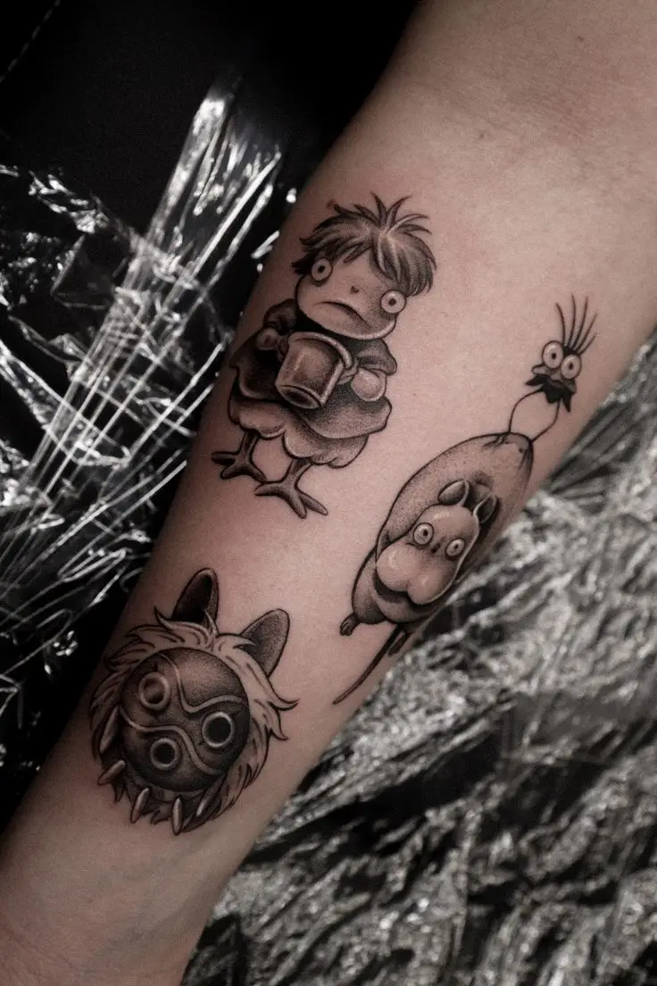 Anime Tattoo auf dem Unterarm mit mehreren Ghibli-inspirierten Figuren in Black and Grey